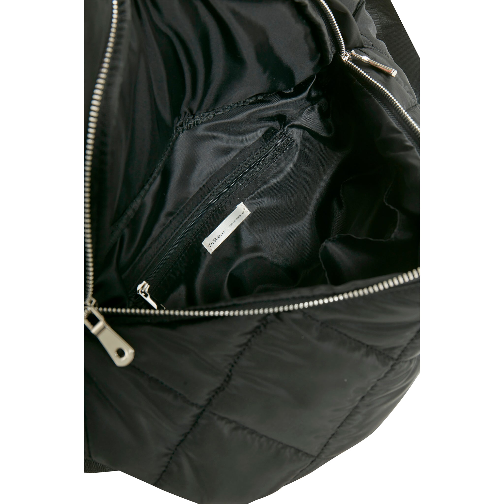 In Wearin ns. crossbody laukku. Musta tikkikangas. Lähikuva.